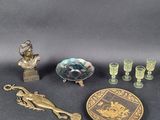 several pieces of antique glass and brass items on a black surface