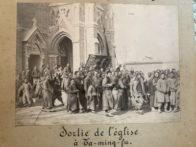 an old picture of a group of people standing outside of a building