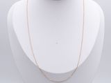 a white mannequin with a gold chain on it