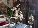 a statue of a man riding on a horse in a living room