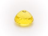 a yellow sapphire stone on a white background