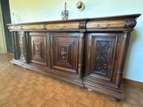 a large wooden cabinet with carvings on the top
