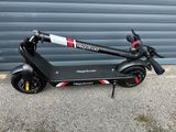 a scooter that is parked in front of a garage door