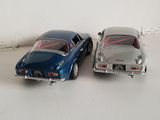 two toy cars sitting next to each other on the floor