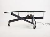 an image of a coffee table with wheels and a glass top