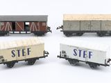 four toy train cars are lined up in a row on a white surface