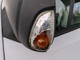 a close up of a car ' s headlight with a reflection on it