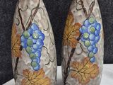 two vases that are painted with grapes on them