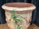 a planter sitting on a table with a curtain in the background