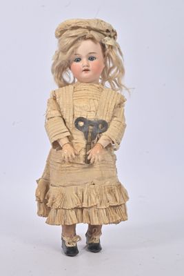 a doll that is holding a pair of scissors in it ' s hands