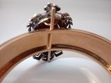 a close up of a ring with a cross on top of it
