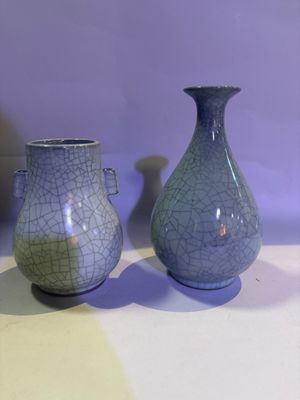 two vases that are sitting on a table