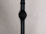 the watch is laying on a table with a white background