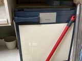 an image of a kitchen with a trash can and a mop