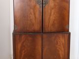a wooden cabinet that is sitting on a hard wood floor