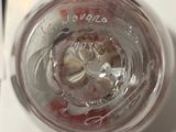 a close up of a glass of water with a spoon in it