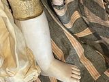 a close up of a doll ' s feet on a blanket