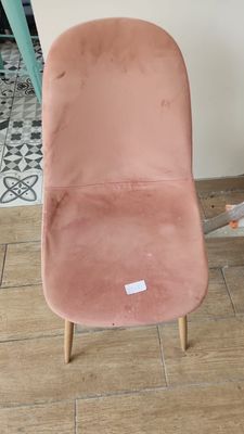 a pink chair that is sitting on the floor