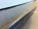 a close up of a car ' s bumper with scratches on it
