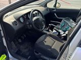 the interior of a car with the door open and the driver ' s seat down