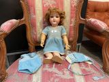 a doll that is sitting on a chair in a room
