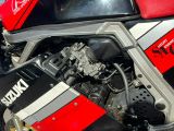 un gros plan d'une moto dont le moteur est rouge et noir