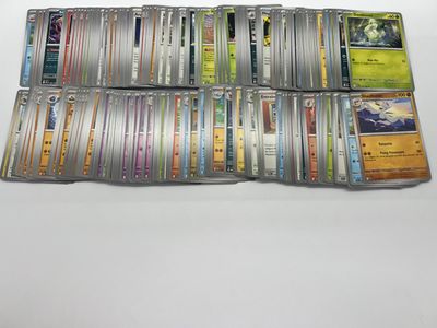 a large collection of pokemon trading cards on a table