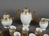 a white and gold tea set with cups and saucers