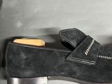 pair of men ' s black sued slippers with a leather sole