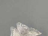 a glass bird that is sitting on top of a table