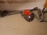 a vacuum that is sitting on the floor next to the wall
