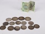a pile of coins sitting on a table next to a note