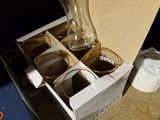 a person pouring something into a glass in a box