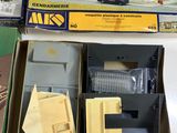 two boxed model kits of a house and a car in a box