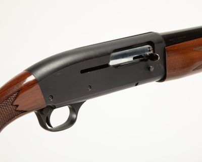 a close up of a shotgun on a white background