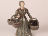 figurine of a woman with a basket of apples