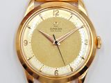 an image of a close up of a gold watch on a white surface