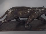 bronze sculpture of a panther on a marble base