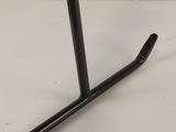 a close up of a table with a black metal base and a white background