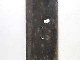 a rusted metal door handle on a white wall