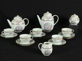 a group of tea and coffee cups and saucers on a table