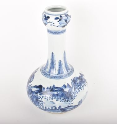 a blue and white vase sitting on a white surface