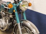 a blue motorcycle parked in a garage with a blue wall