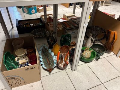 a table with a bunch of vases and bowls on it