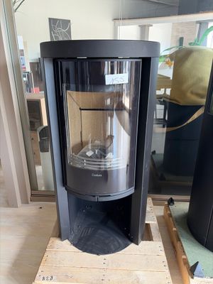a black stove sitting on a pallet in a room