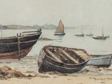 two boats that are sitting on the beach