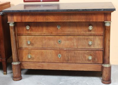 a wooden chest of drawers with a marble top