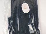 a black shirt in a plastic bag on a table