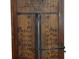 an old wooden clock with a metal handle on it