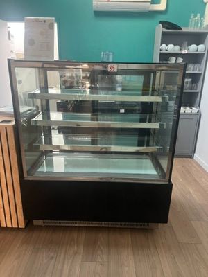 a glass display case in the middle of a room
